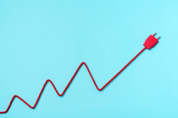 Red Electric Power Plug and cable forming a chart on blue background. usage based pricing